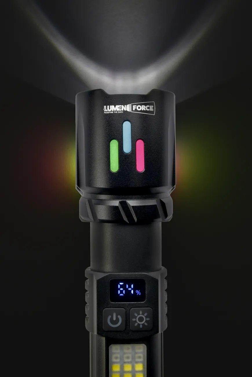 Lumen Force LM-MFL01 flashlight head-on, its beam splaying upward into the dark, the colored indicator lights and LCD battery display glowing, with the dual switches and COB work light visible.