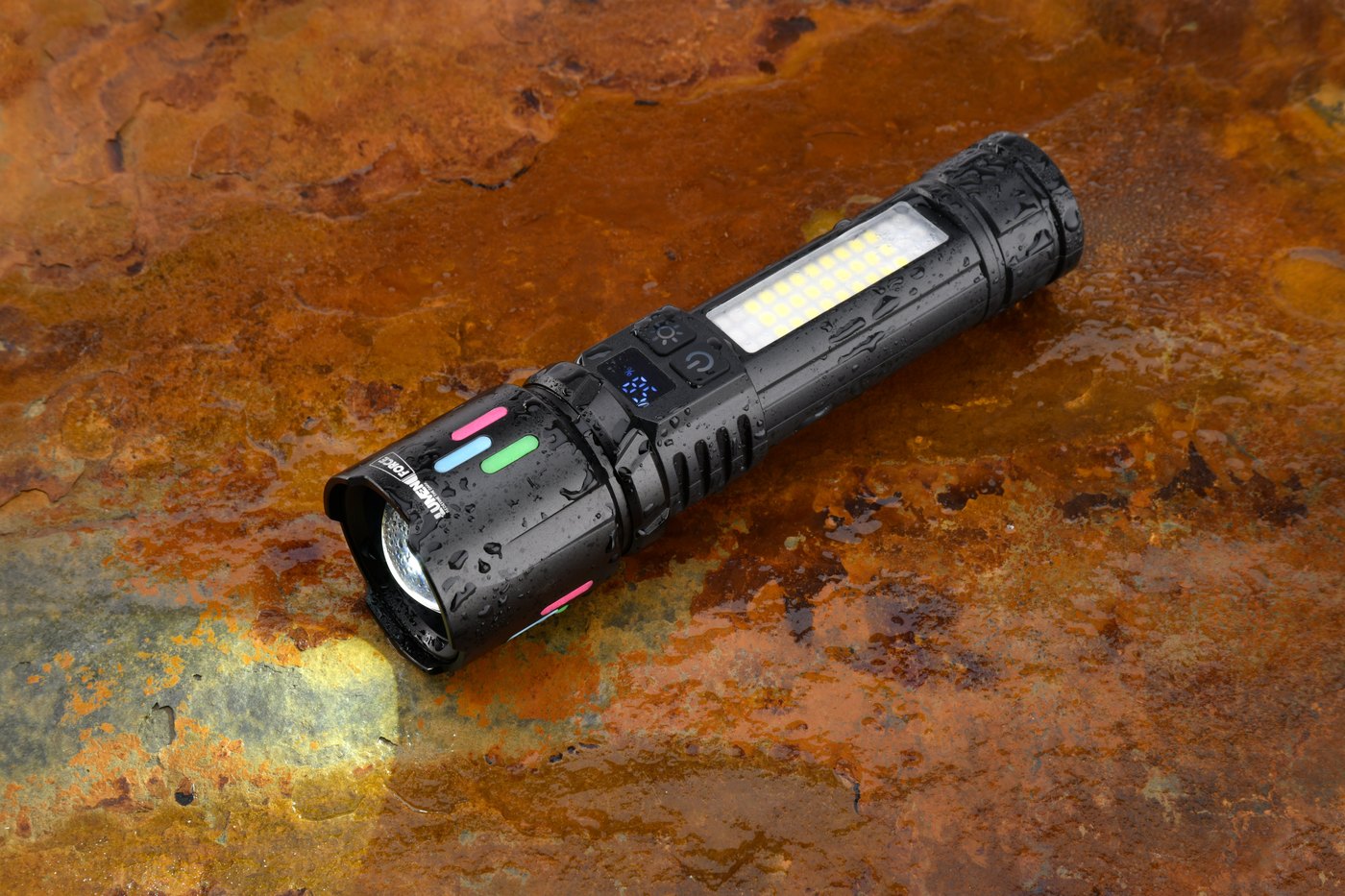 Lumen Force flashlight resting on a rugged industrial surface, showing its aluminum head and controls